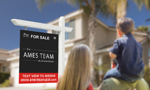 people looking at a house with a For Sale advertisement by The Ames Team