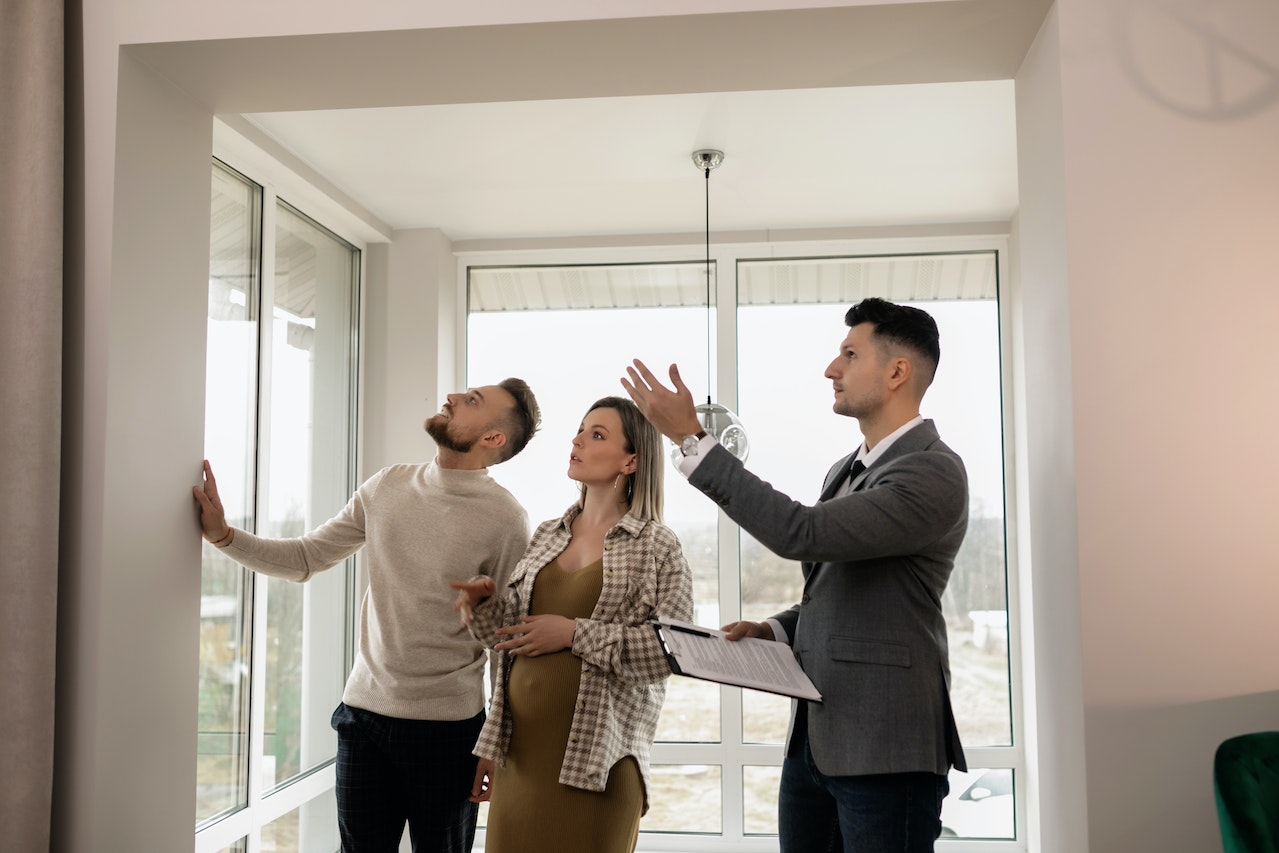 a real estate agent showing a house to a couple