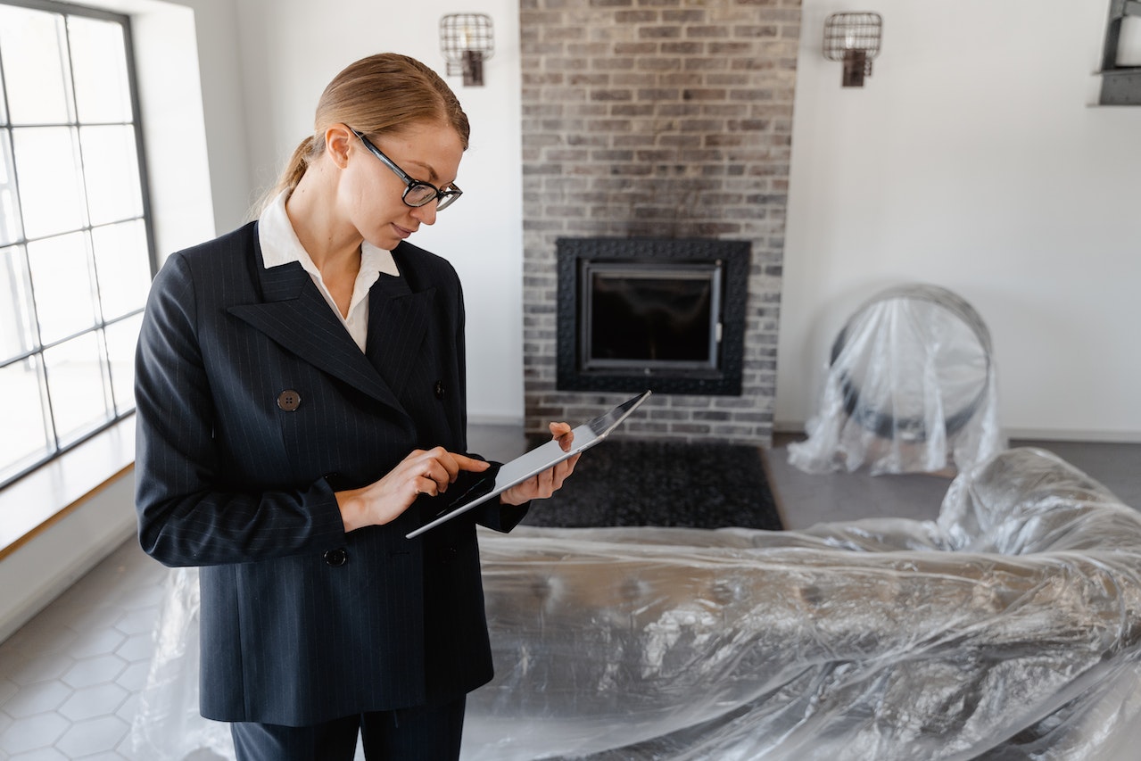 a realtor woman checking something on her tablet